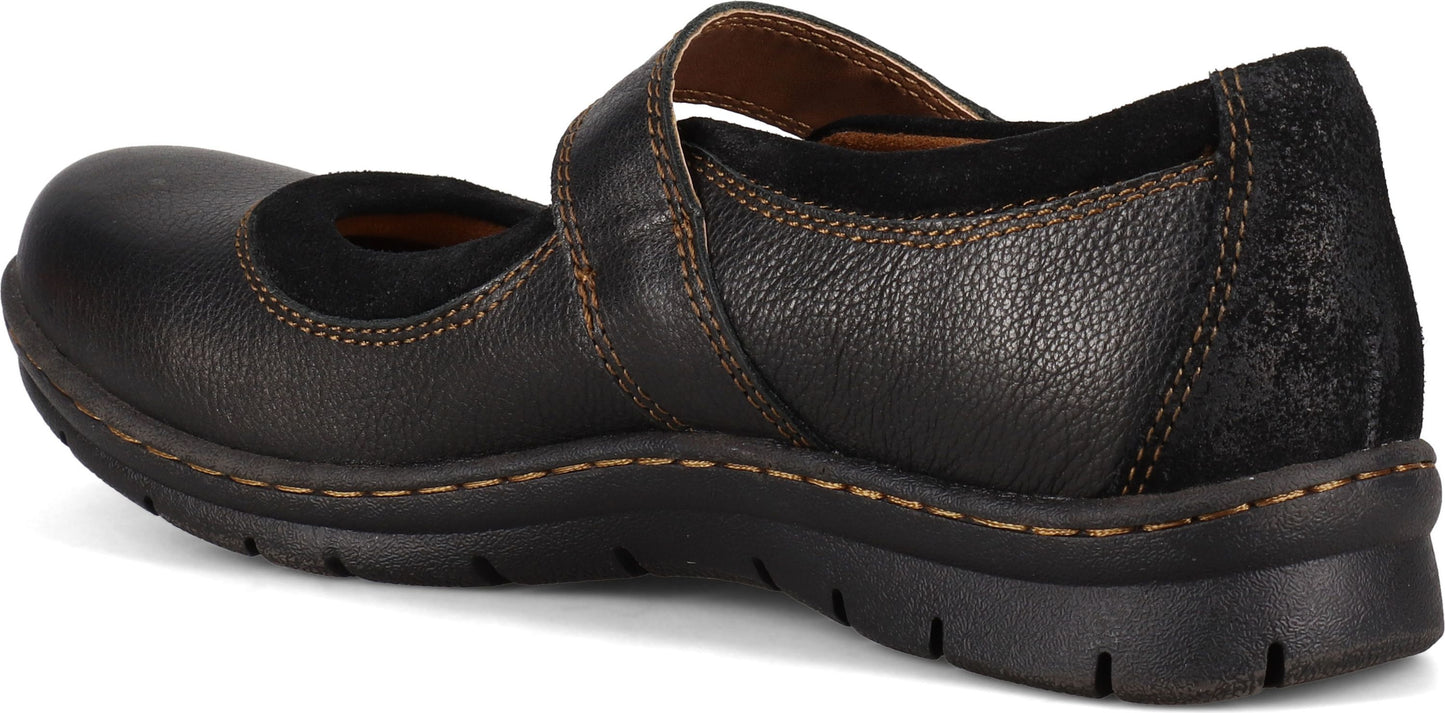 A dark colored Mary Jane style shoe with a strap across the top.