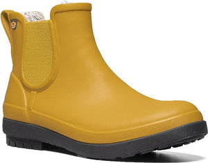 Close-up of a mustard yellow ankle-height boot with grey sole, elastic ankle inserts, and pull tab.