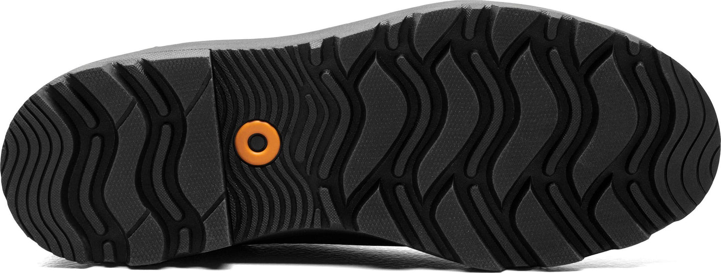 The outsole of a shoe, featuring a curved wavy tread pattern and a circular indentation with an orange fill.