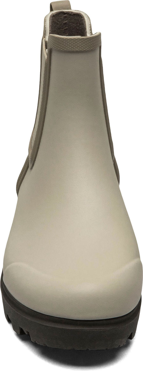 Front view of a beige chelsea boot with a brown sole.