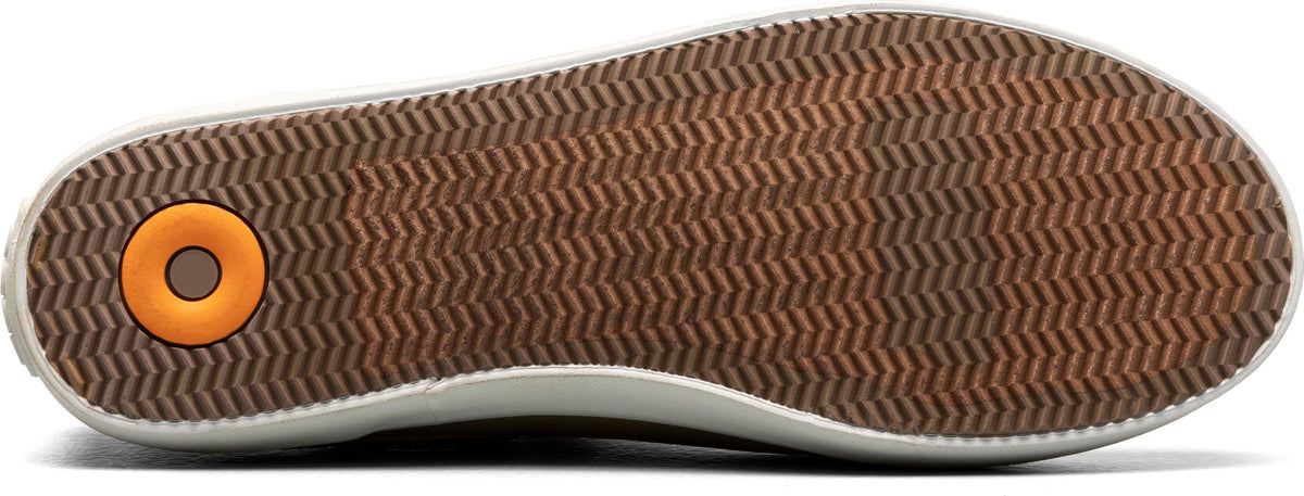 Sole of a shoe with a brown zig-zag tread pattern and an orange circular inset.