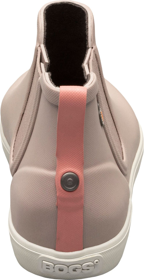 A light pink ankle boot with a white sole and a pink pull tab with a button.
