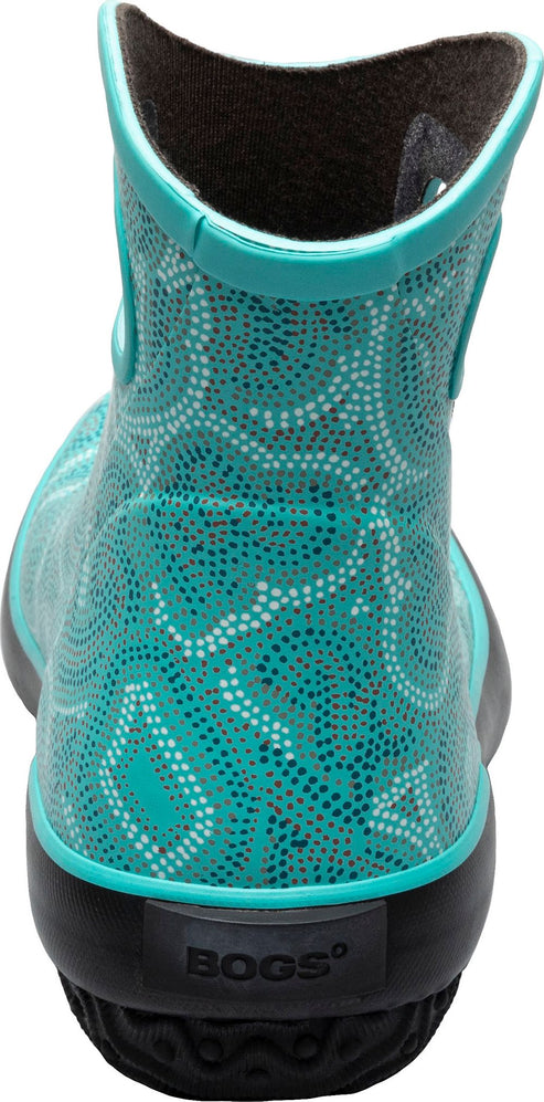 A turquoise boot with white polka dots and a black sole.