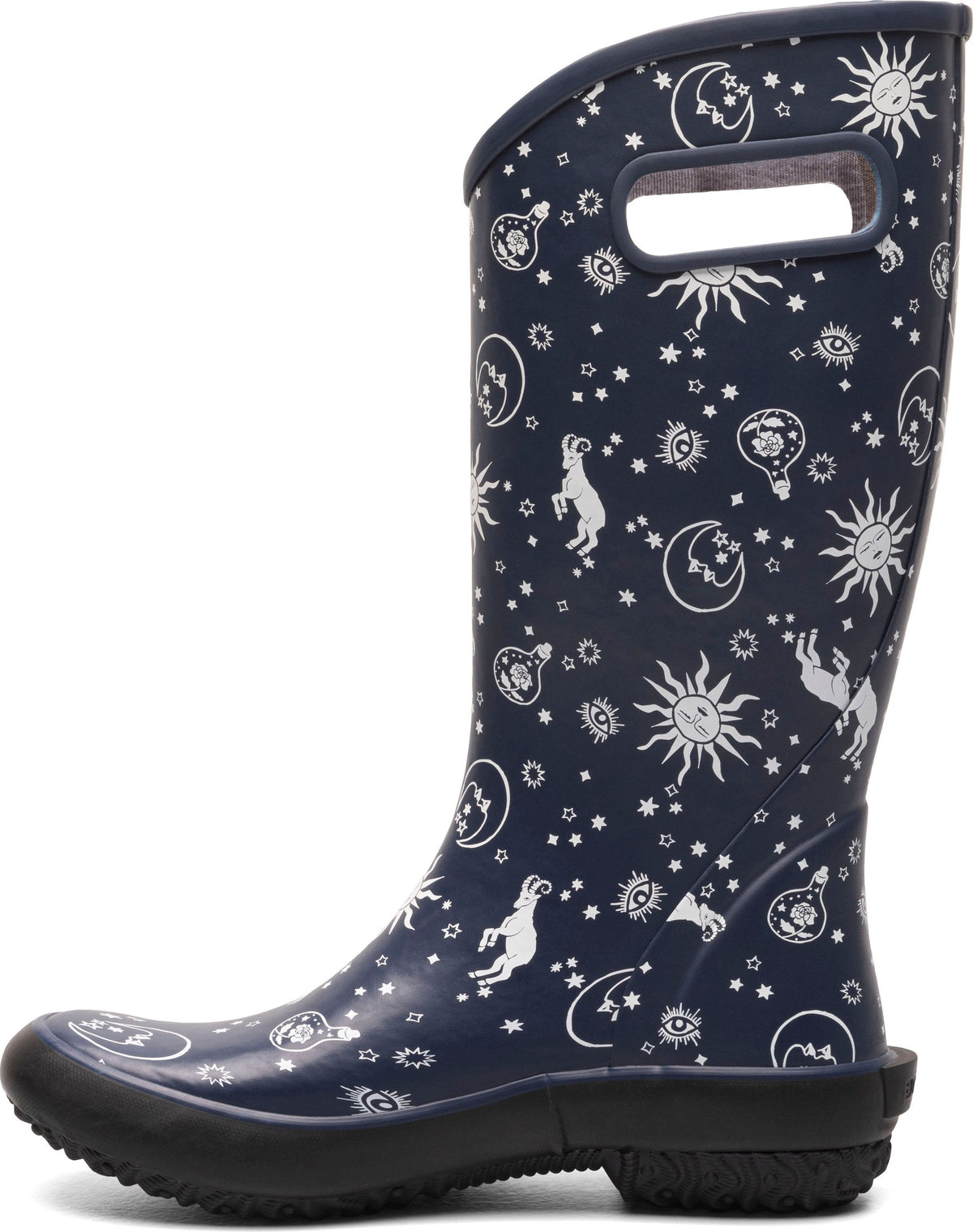 Navy blue rubber rain boot with celestial print, including suns, moons, and stars.