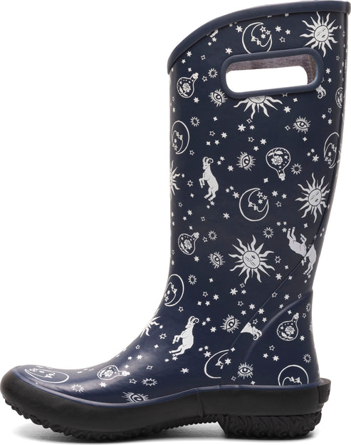 Navy blue rubber rain boot with celestial print, including suns, moons, and stars.