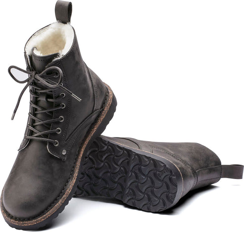 Pair of ankle-high lace-up boots in gray with light-colored lining and looped heel tab.