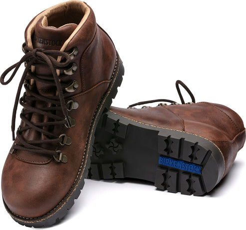 Pair of brown leather hiking boots with laces.