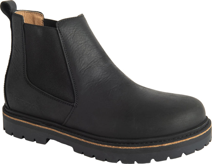 Black leather ankle-high Chelsea boot with elastic side panels and a thick, lugged sole.