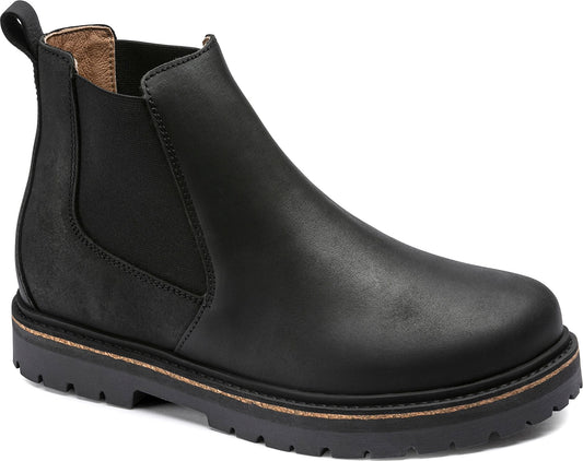 Black leather chelsea boot with lug sole.