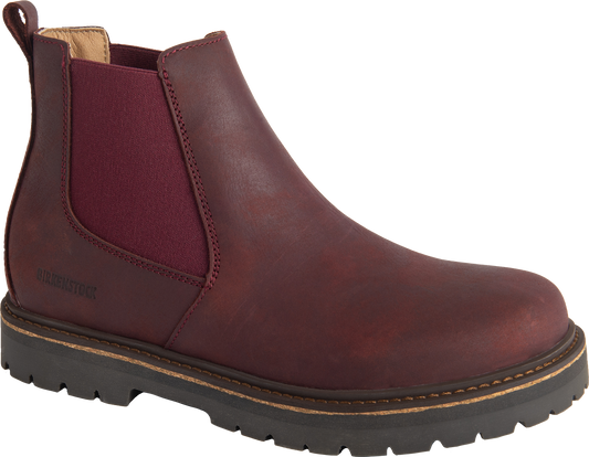 A wine-colored leather chelsea boot with a lug sole.