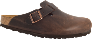 A brown leather clog with a cork footbed and adjustable strap.