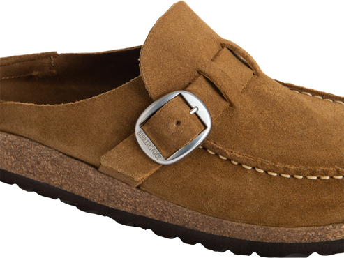 Close-up of a brown suede clog with a silver buckle featuring the text BIRKENSTOCK.