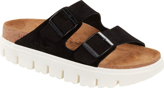 Black slide sandal with two adjustable buckle straps, a cork footbed, and a thick white lug sole.