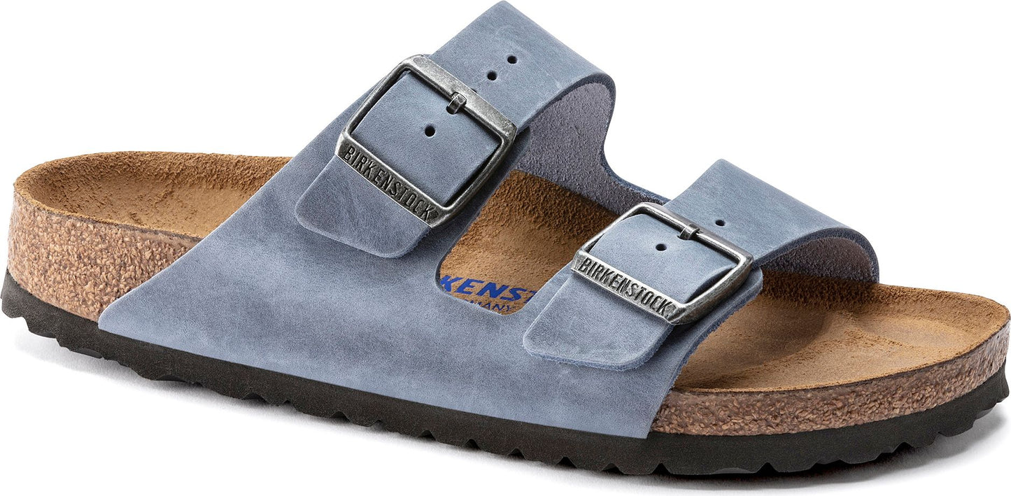 A pair of light blue suede sandals with two straps and metal buckles.
