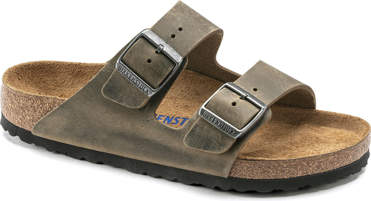 Two-strap slide sandal with silver buckles and cork sole.