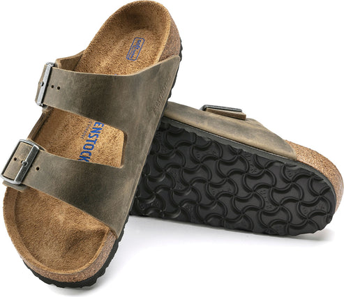 Pair of brown leather sandals with two straps and buckle closures, showing footbed and sole.