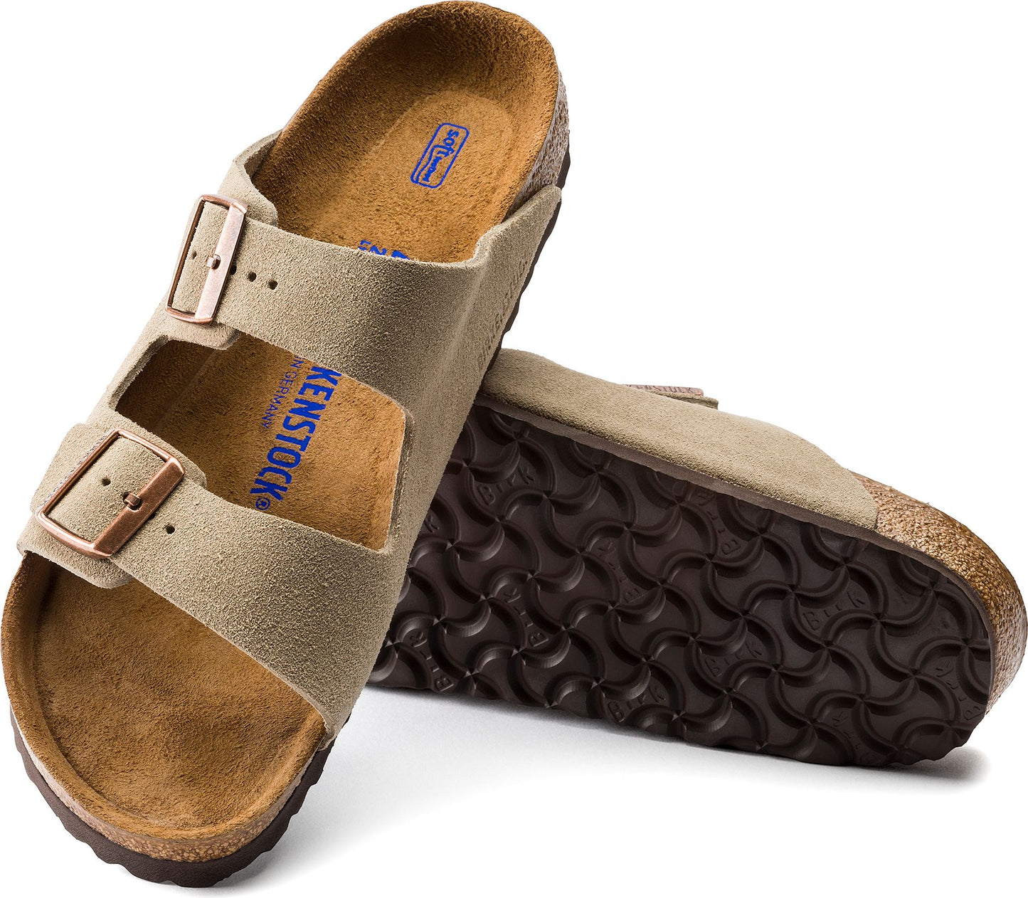 Two suede sandals with adjustable buckle straps, cork sole, and patterned brown tread.