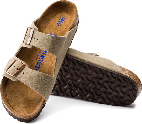 Two suede sandals with adjustable buckle straps, cork sole, and patterned brown tread.