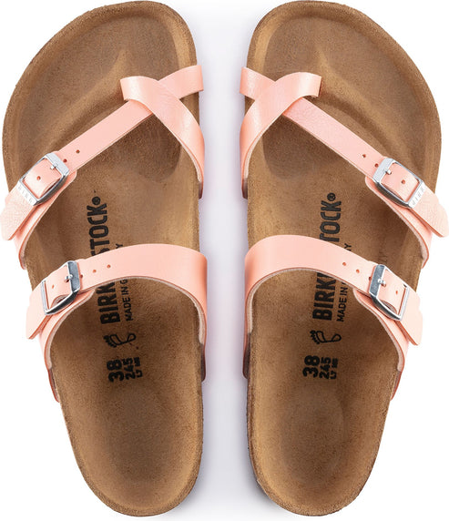 Overhead shot of a pair of pink sandals with adjustable straps and silver buckles. The footbed has "BIRKENSTOCK" text printed on it.