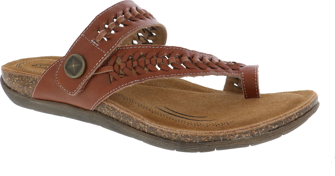 A brown sandal with a braided strap over the toes and a decorative button on the side.