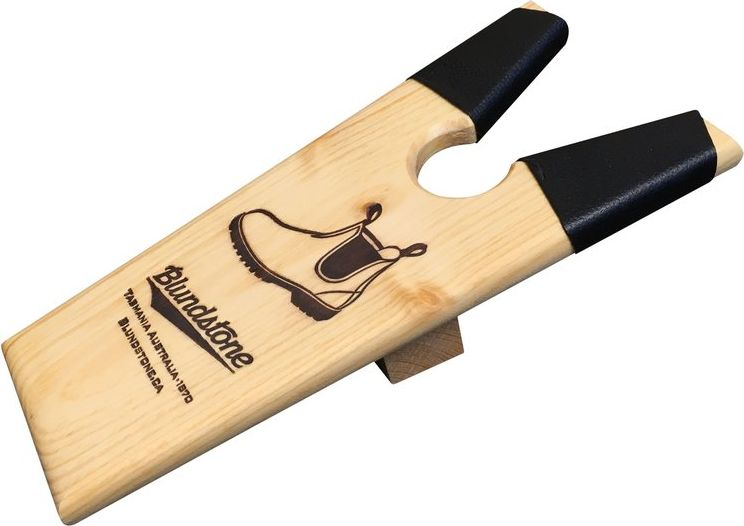 Wooden boot jack with black padded arms and a logo of a boot and the text "TASMANIA AUSTRALIA 1870".