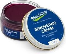 Open tin of cherry colored renovating cream with blue label and silver edge.