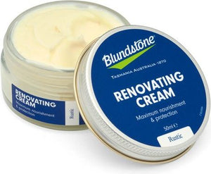 An open jar of renovating cream with an open lid that reads: Renovating cream, maximum nourishment and protection, and Rustic on a blue background.