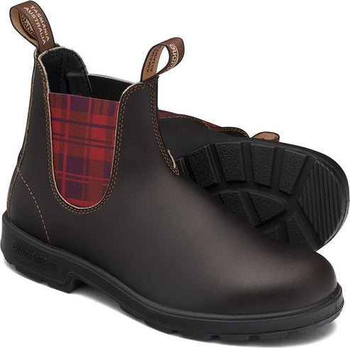 A pair of brown leather Chelsea boots with plaid elastic side panels.