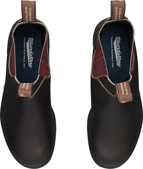 A top-down view of a pair of brown leather boots, with elastic side panels and plaid interiors.