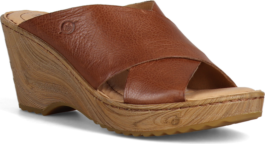 Brown leather wedge sandal with overlapping straps.