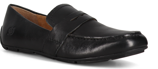 A black leather loafer shoe with a visible decorative strap across the top.