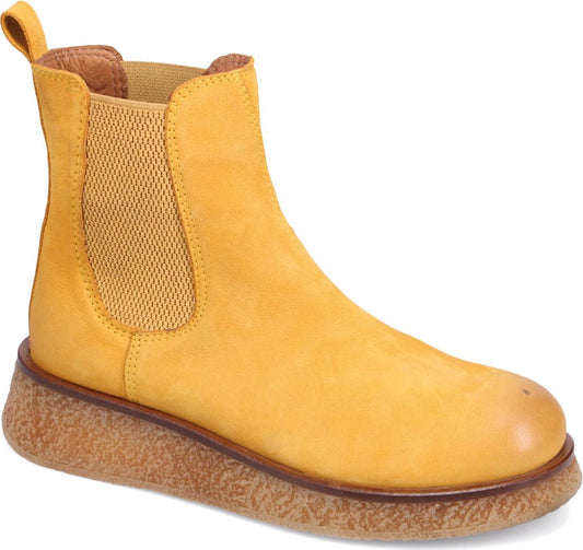 Yellow ankle boot with elastic side panels and thick sole.