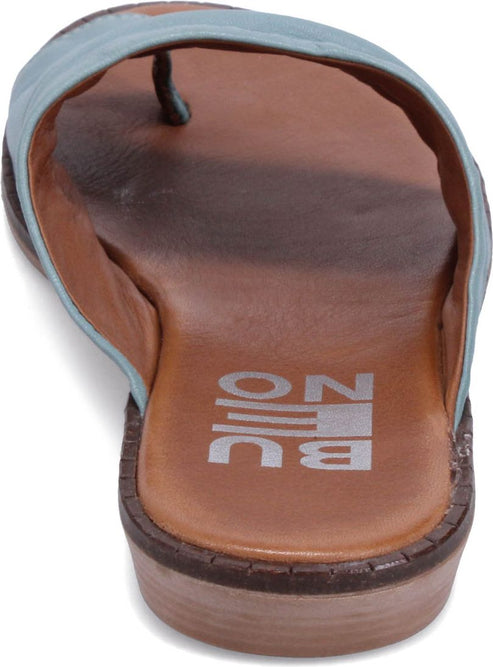 Close-up of a tan sole sandal with light blue straps.