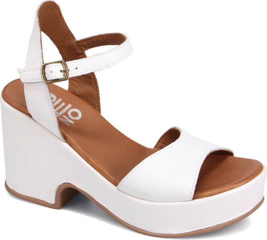 White wedge heel sandal with ankle strap.