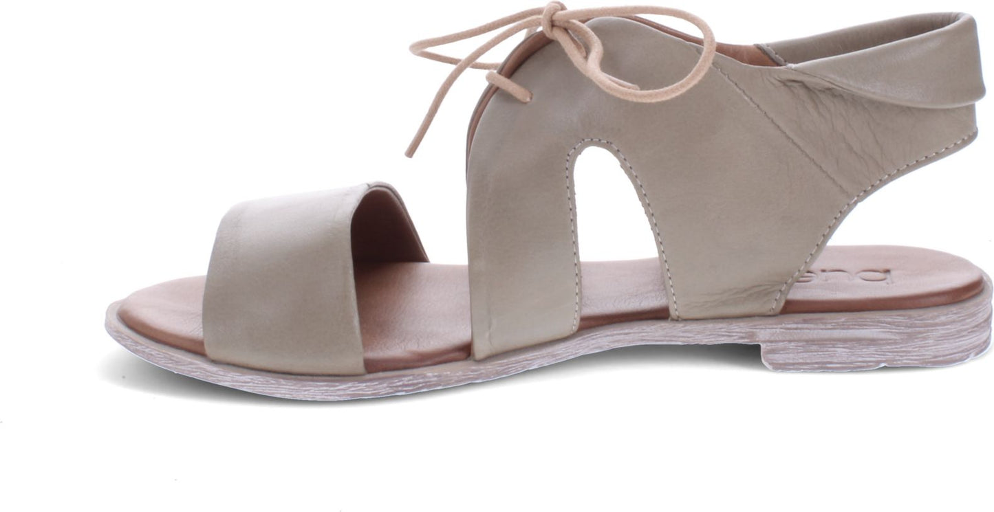 Beige leather sandal with tie closure.