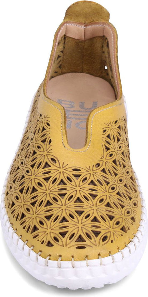 Yellow slip-on shoe with floral cutouts and white sole.