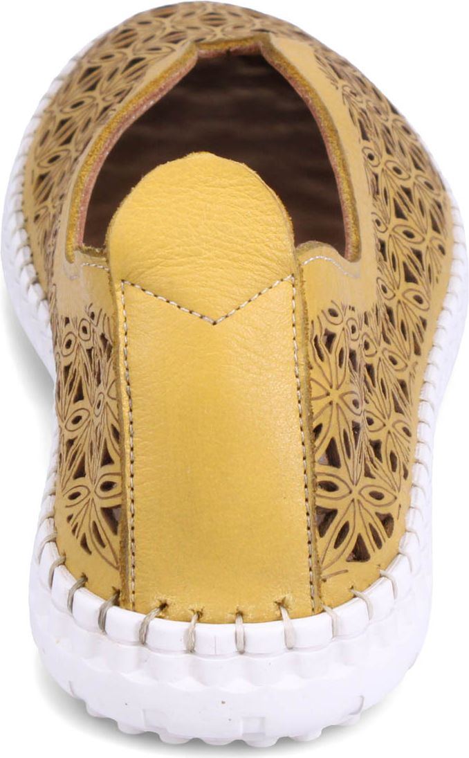 Yellow slip-on shoe with cut-out floral pattern and white sole.