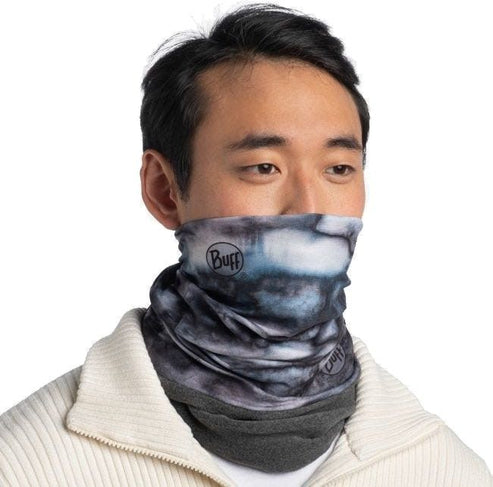 Person wearing a blue, black, and grey neck gaiter that reads "Buff" in a circular logo and at the bottom right.