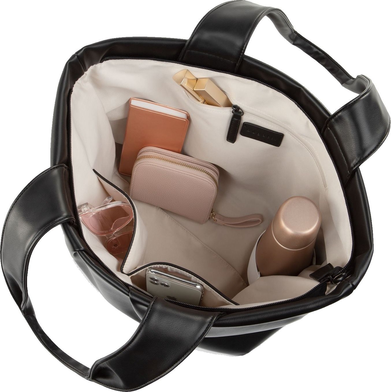 Open black tote bag, overhead view, reveals light lining, zippered compartment, and pockets holding a peach wallet, a pink wallet, perfume, water bottle, a smartphone, and a snack.