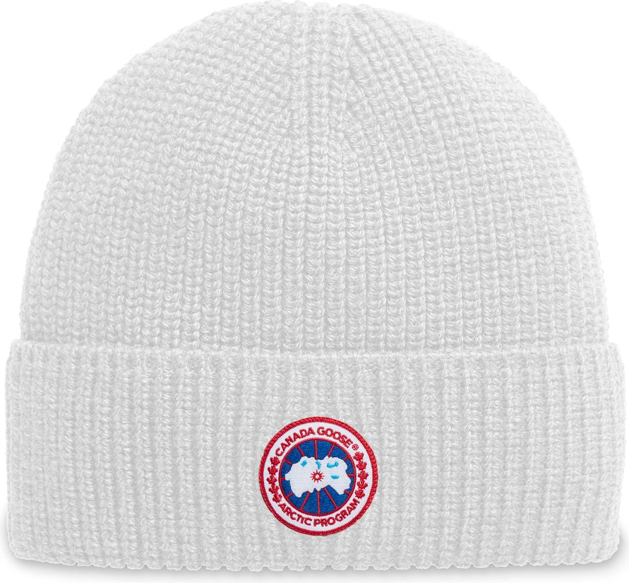 White knit beanie with circular logo featuring a goose and the text 'CANADA GOOSE ARCTIC PROGRAM'.