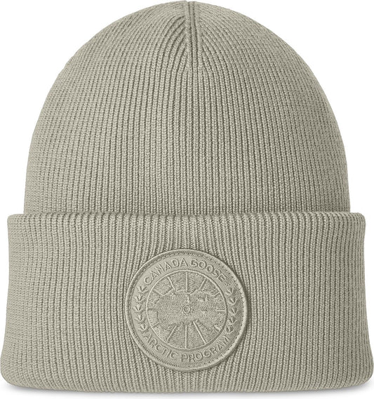 Gray knit beanie with a circular arctic program logo emblem.