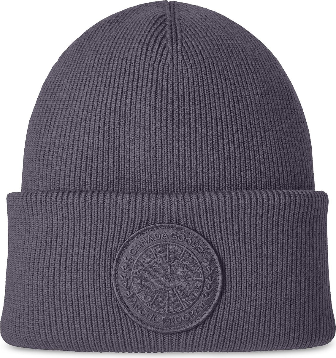 Gray knit beanie hat with circular emblem.