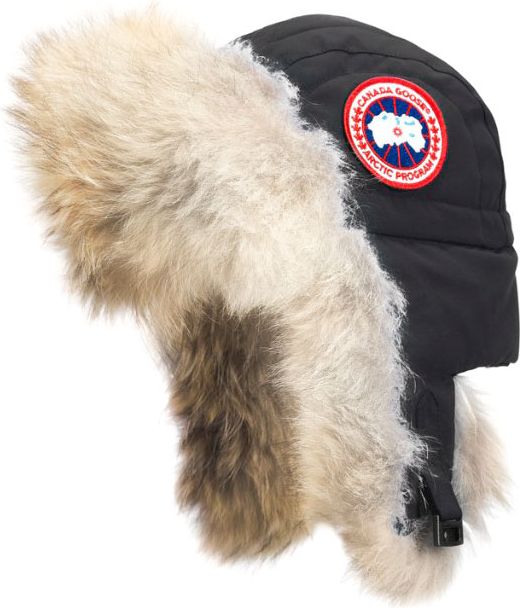 Black trapper hat with fur trim and a red, white, and blue circular patch.