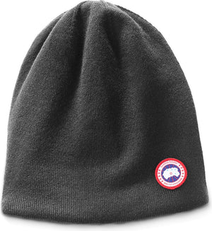 Charcoal gray knit beanie hat with red circular logo.