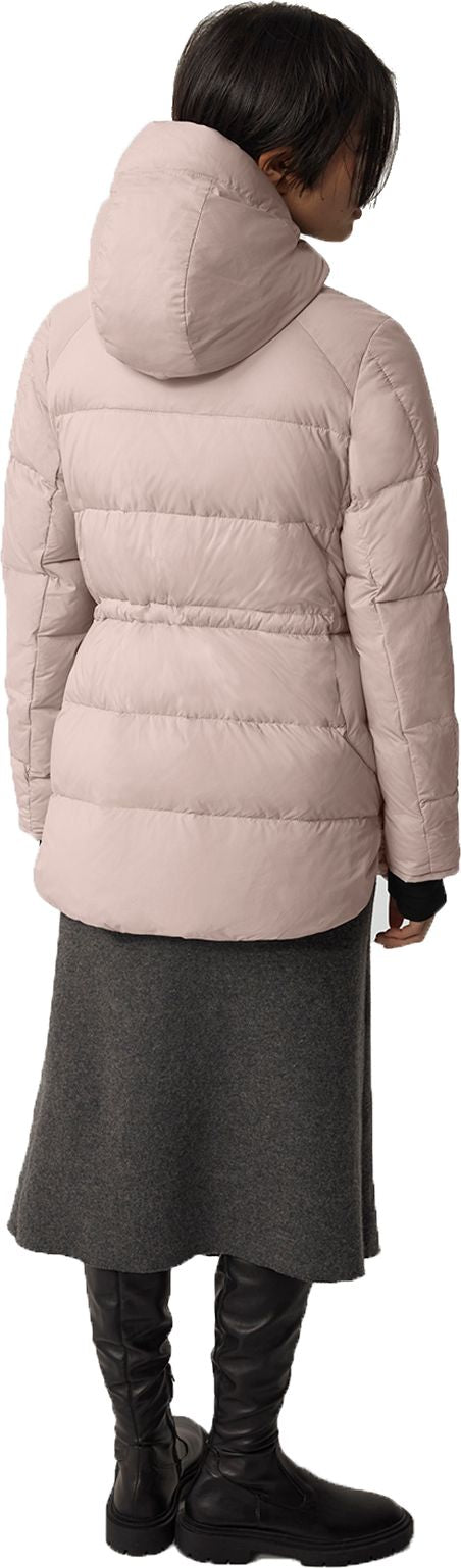 A person wearing a pink puffer coat, a grey skirt, and black boots, facing away from the camera.