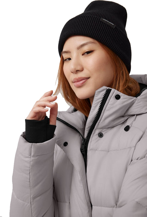 Person wearing a black beanie and a light gray puffer jacket.