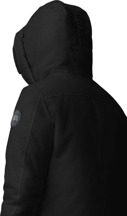 Black hooded winter parka, back view showing logo patch on upper left sleeve.