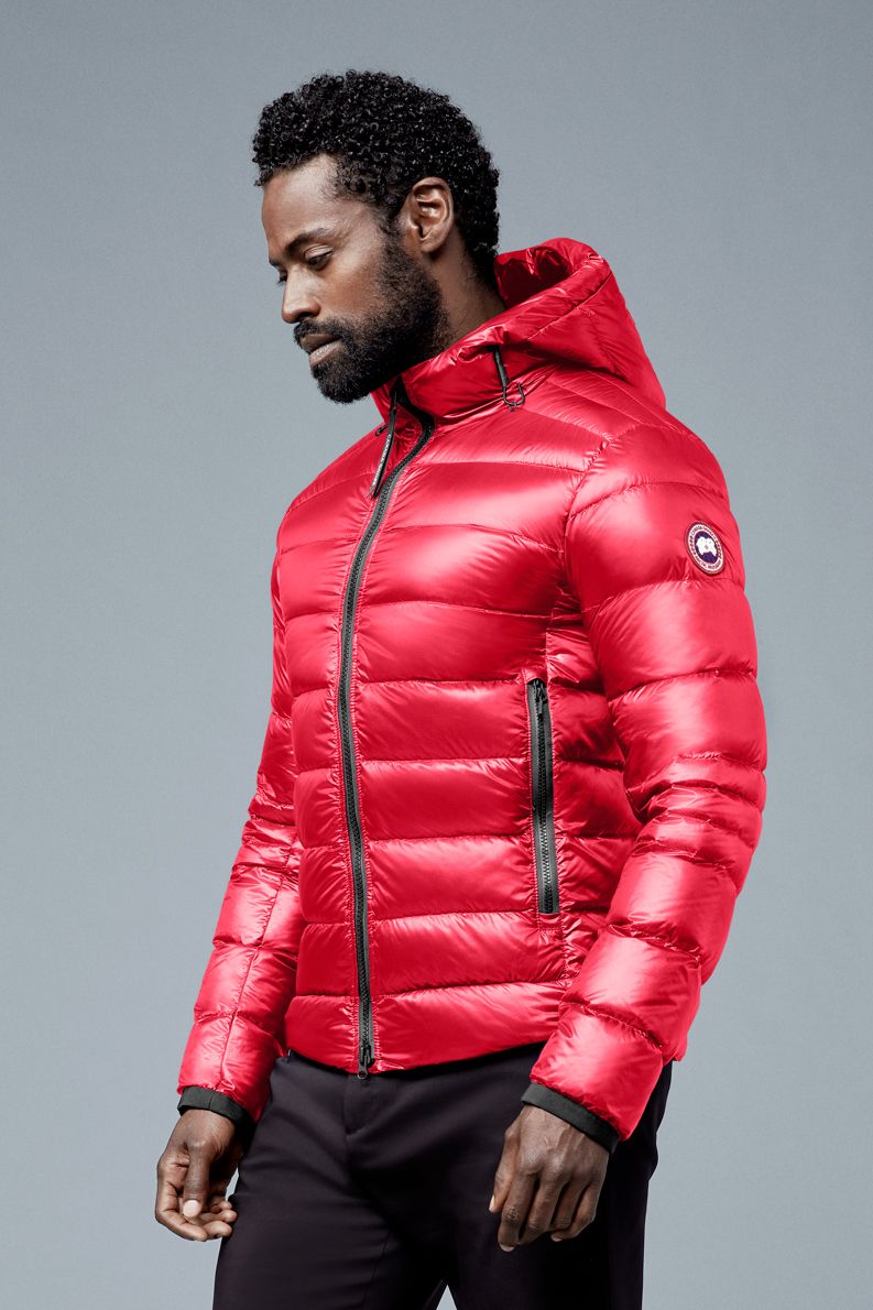 Man wearing red down puffer jacket with hood.