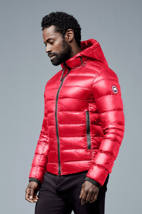 Man wearing red down puffer jacket with hood.
