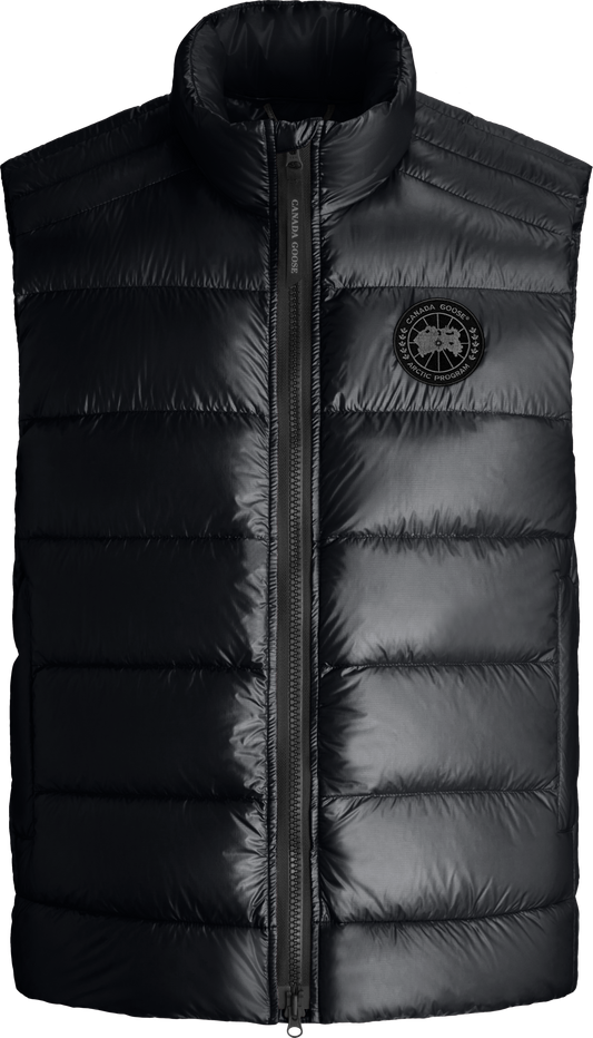 Black quilted puffer vest with central zipper and round logo patch.